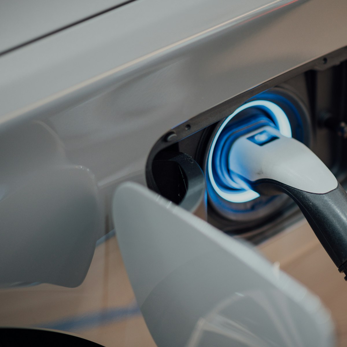 Electric vehicle plugged into a charging station
